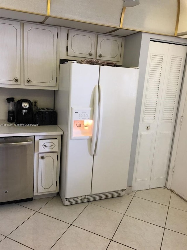 kitchen featuring dishwasher, white fridge with ice dispenser, and light tile patterned floors