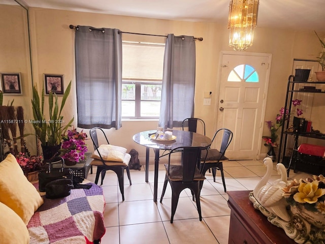 dining area with a notable chandelier and light tile flooring