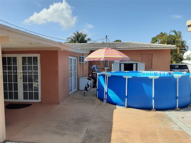 view of pool featuring french doors and a patio