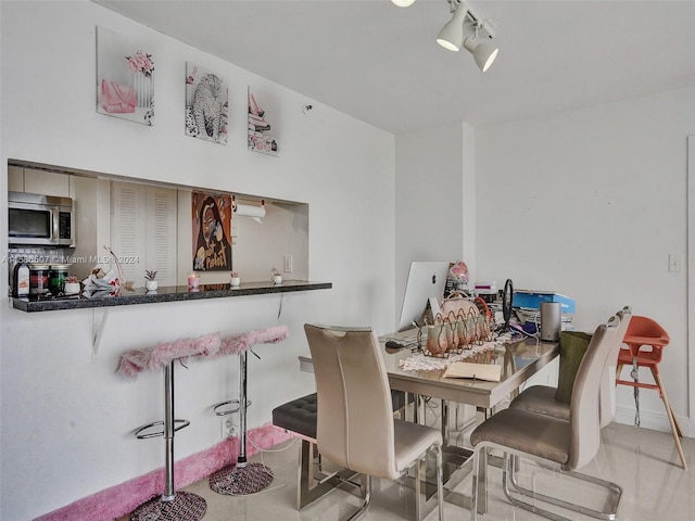 dining area featuring track lighting