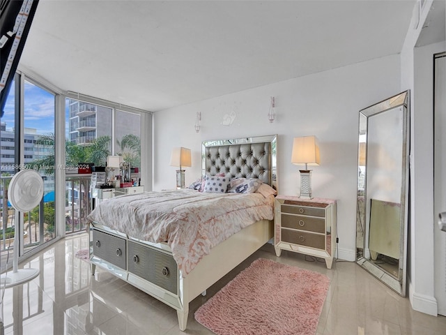 bedroom featuring light tile floors, access to outside, a wall of windows, and multiple windows