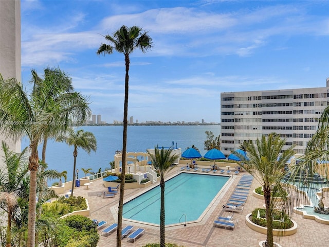 view of swimming pool with a water view