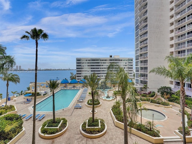 view of swimming pool with a water view