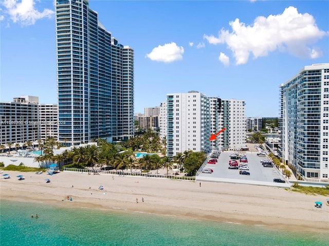 drone / aerial view featuring a water view and a view of the beach