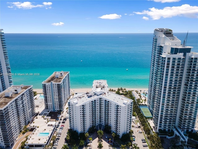 drone / aerial view with a beach view and a water view