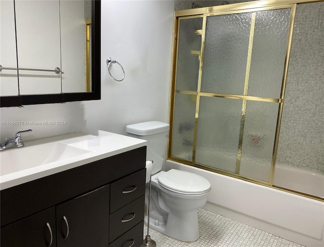 full bathroom featuring shower / bath combination with glass door, tile flooring, toilet, and large vanity