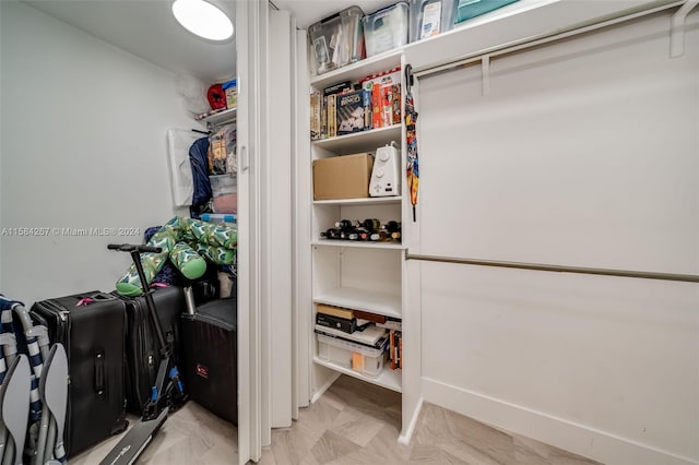 walk in closet with light parquet flooring