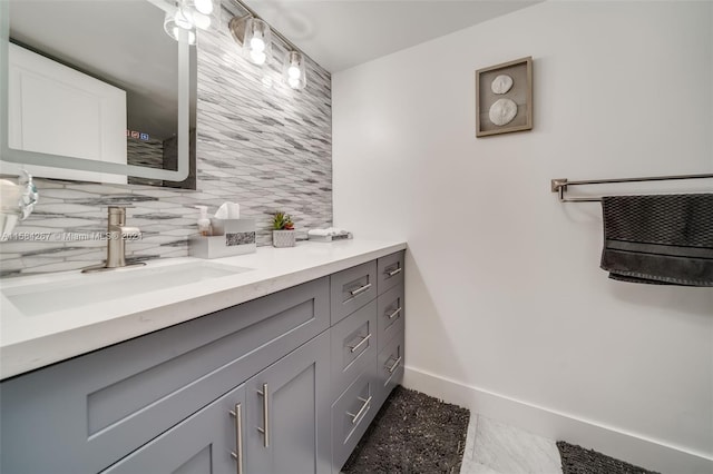 bathroom featuring tile flooring, tasteful backsplash, and vanity