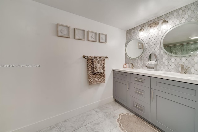 bathroom with double vanity, tile flooring, and tasteful backsplash