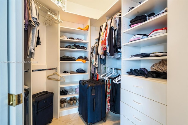 walk in closet featuring light tile floors