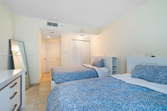 tiled bedroom with a closet