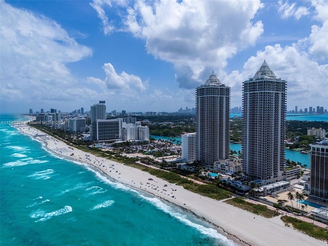 birds eye view of property featuring a view of the beach and a water view