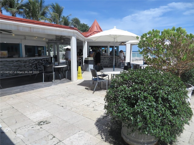 view of patio / terrace featuring outdoor dry bar and outdoor dining space