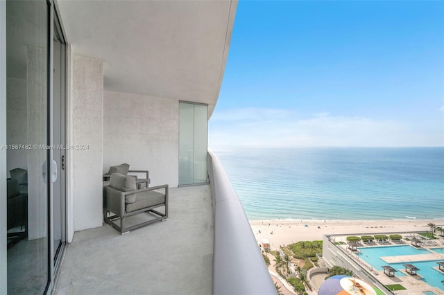 balcony with a beach view and a water view