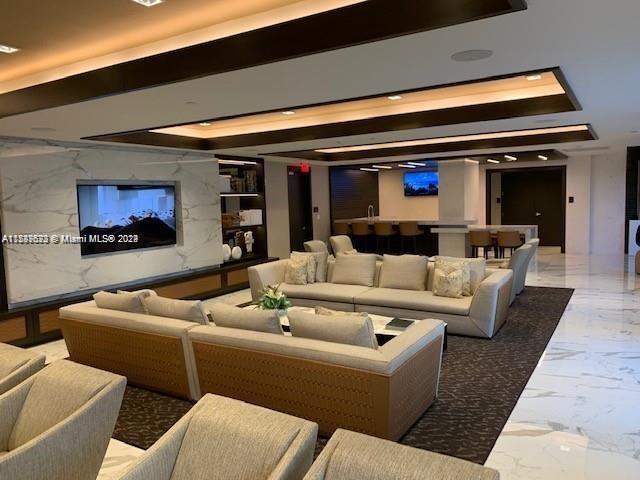 home theater room with marble tiled floors