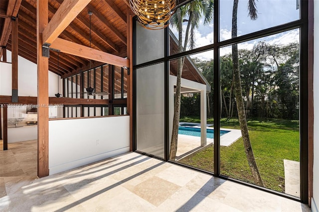 interior space with vaulted ceiling with beams, wood ceiling, expansive windows, and a chandelier