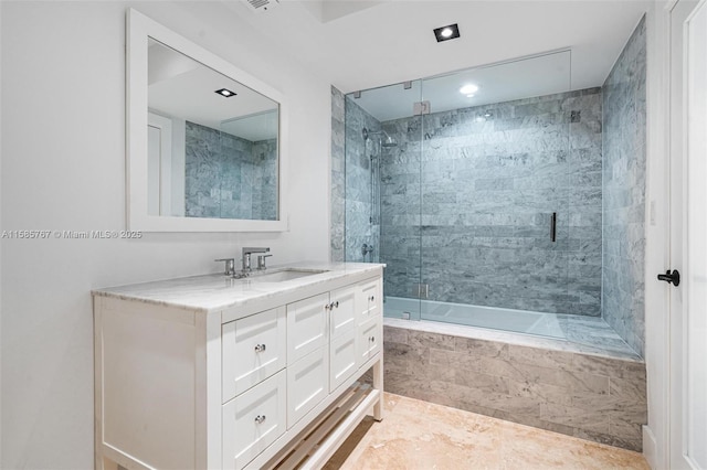 bathroom featuring vanity and shower / bath combination with glass door