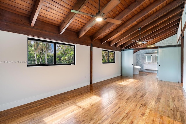 basement with light hardwood / wood-style flooring, wooden ceiling, and ceiling fan