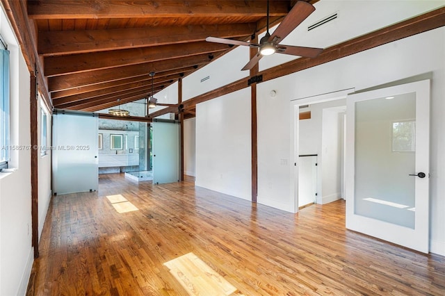 unfurnished living room with vaulted ceiling with beams, wooden ceiling, ceiling fan, and light wood-type flooring