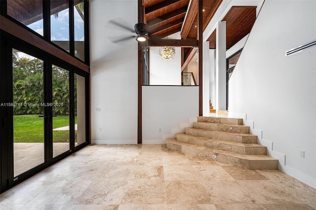 stairs featuring french doors and a high ceiling