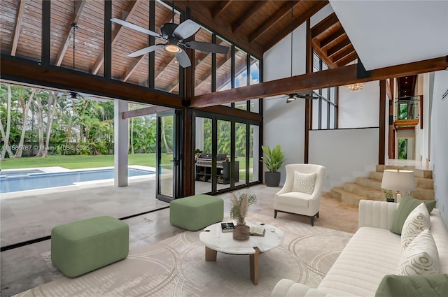 interior space with vaulted ceiling with beams, wood ceiling, and ceiling fan