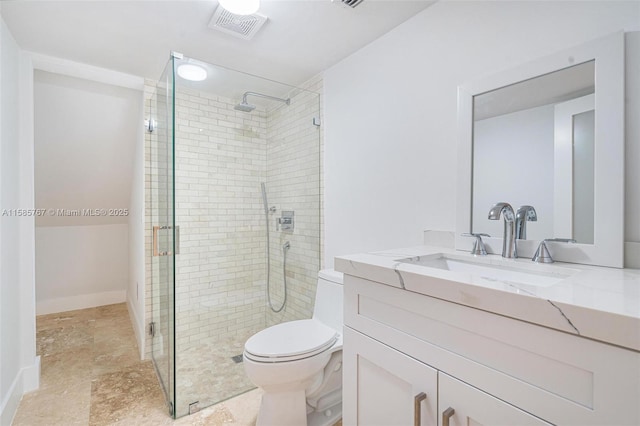 bathroom featuring vanity, toilet, and walk in shower