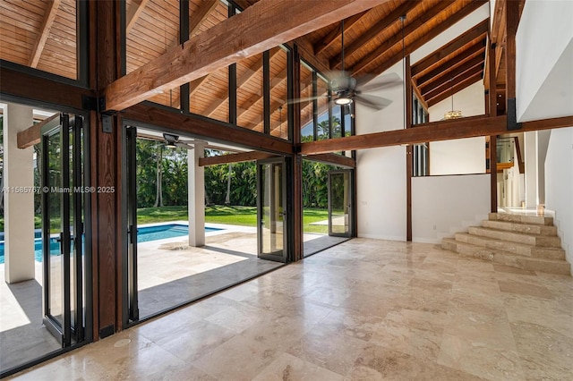 interior space featuring beamed ceiling, ceiling fan, high vaulted ceiling, and wooden ceiling