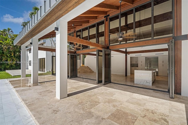 view of patio featuring ceiling fan