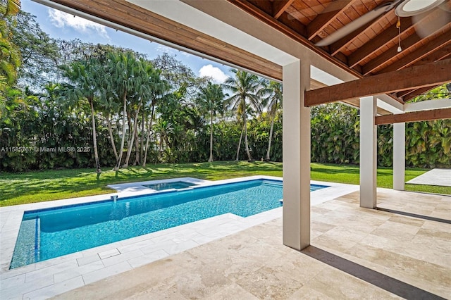 view of pool with an in ground hot tub, a yard, and a patio area