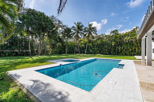 view of swimming pool featuring a lawn and a patio area