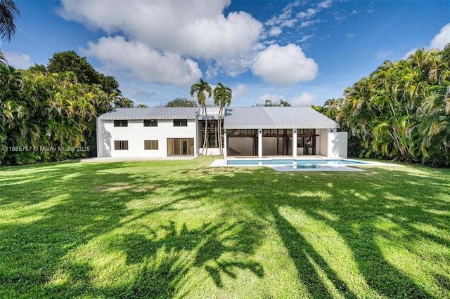 rear view of house with a lawn