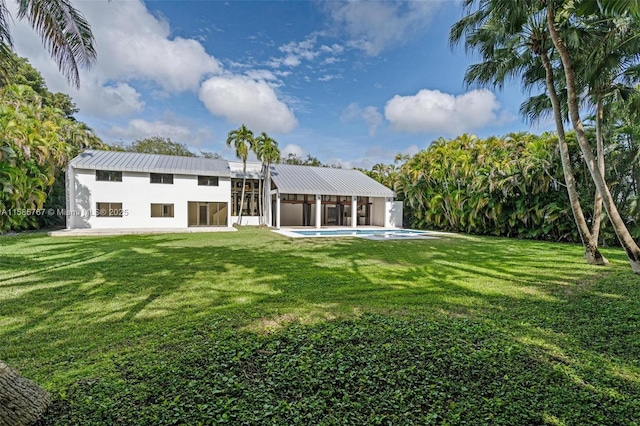 rear view of property featuring a yard