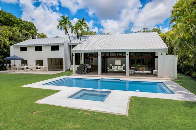 view of swimming pool with an in ground hot tub, outdoor lounge area, a yard, and a patio area