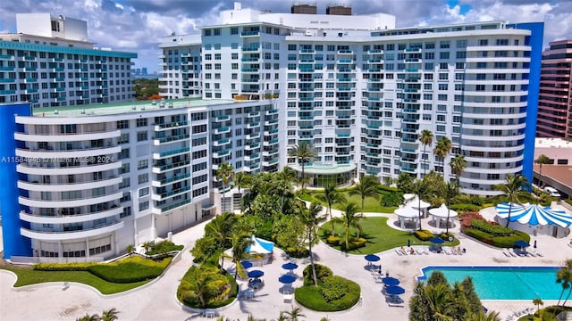 view of building exterior featuring a community pool