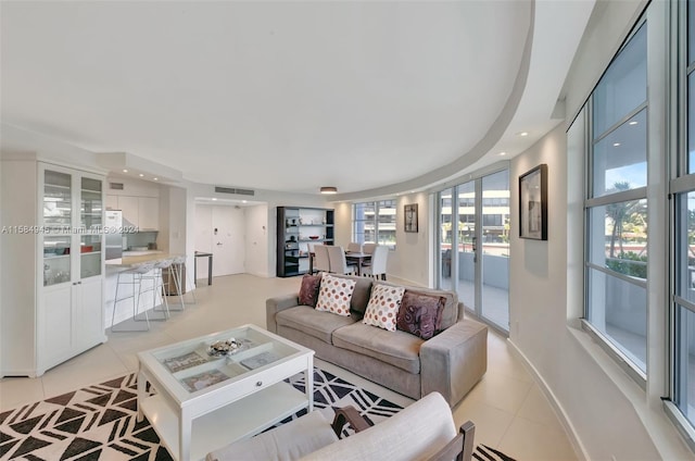 living room with a wealth of natural light and light tile floors