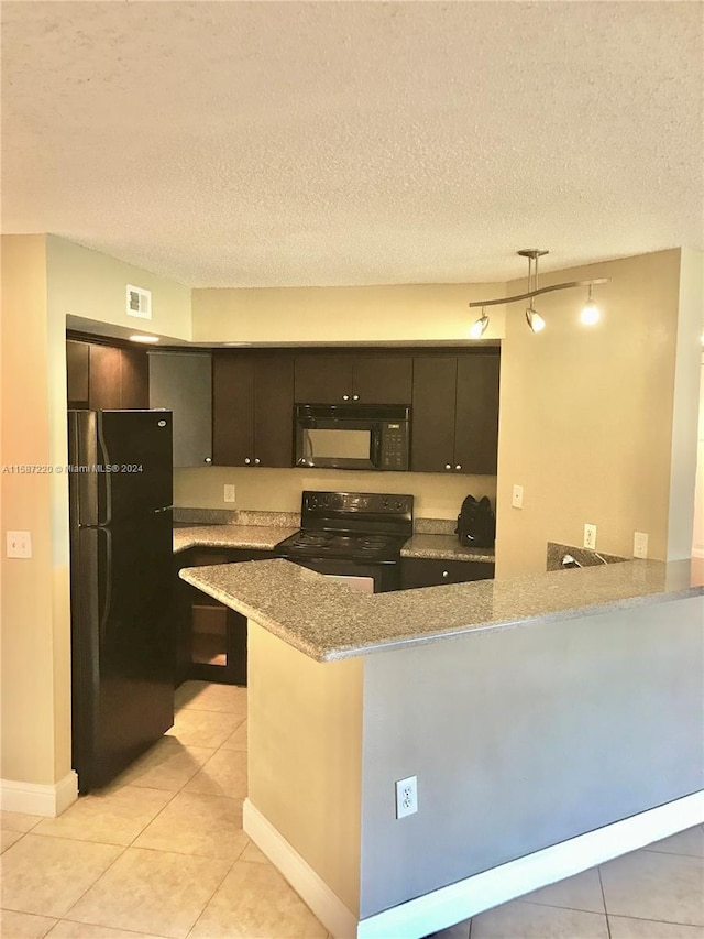 kitchen with black appliances, kitchen peninsula, light tile floors, and rail lighting