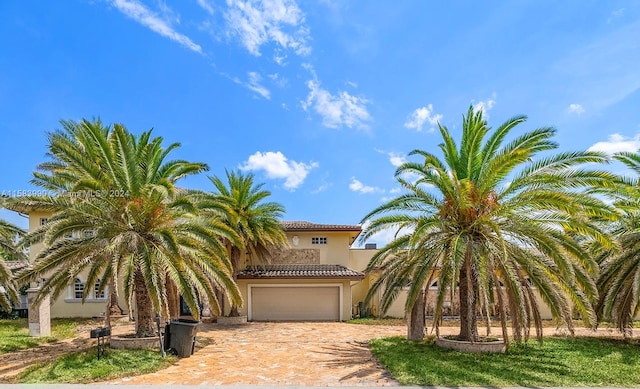 mediterranean / spanish home with a garage