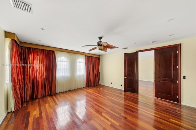 spare room with ceiling fan and dark hardwood / wood-style flooring