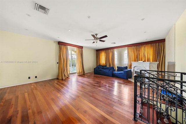 living room with hardwood / wood-style flooring and ceiling fan