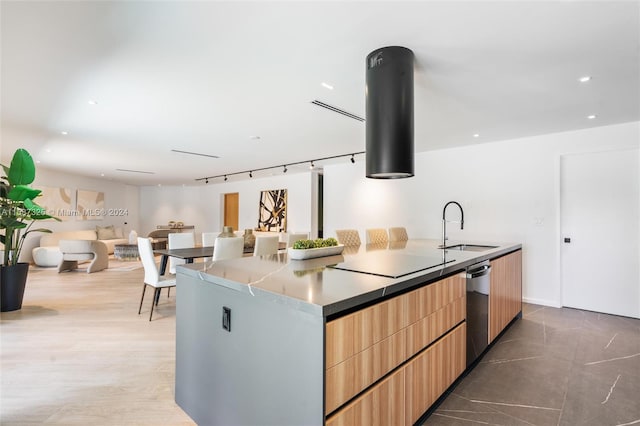 kitchen with dishwasher, sink, a center island, black electric stovetop, and light wood-type flooring