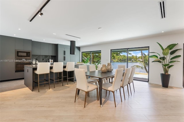 dining area featuring track lighting and light wood-type flooring