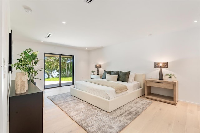 bedroom with access to exterior and light wood-type flooring