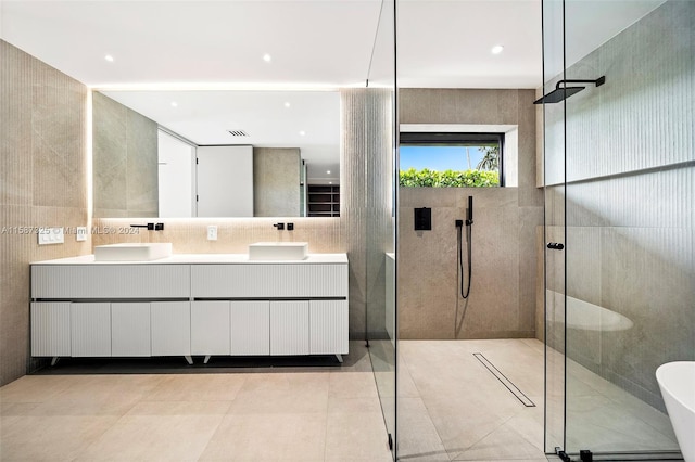 bathroom with vanity, a shower, and tile walls