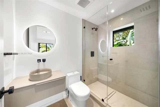 bathroom featuring walk in shower, vanity, and toilet