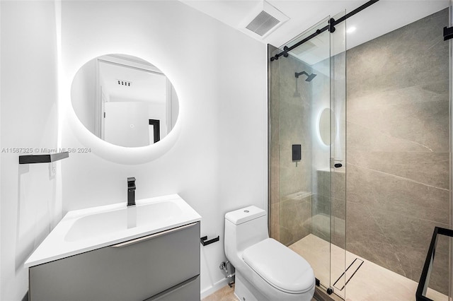 bathroom with vanity, toilet, and a shower with shower door