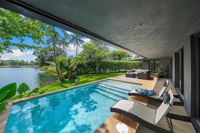 view of pool with an outdoor living space and a water view