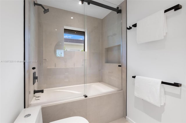 bathroom with bath / shower combo with glass door