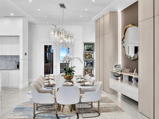 tiled dining room with a notable chandelier