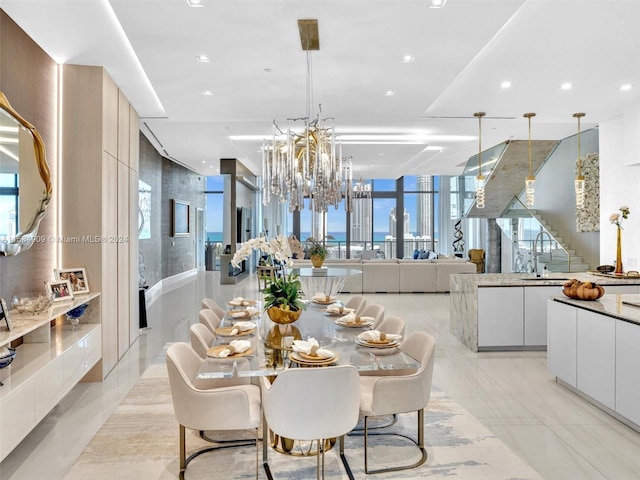 tiled dining area featuring sink, an inviting chandelier, and a wall of windows