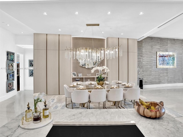 interior space with light stone counters, pendant lighting, and a chandelier